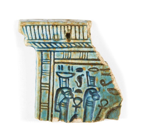 A polychrome glazed composition pylon-shaped pectoral fragment, possibly Egypt New Kingdom, the front in relief depicting Isis in profile wearing the stepped throne crown, the back with two seated deities in sunk relief, each holding an ankh sign...