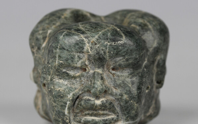 A pre-Columbian Olmec style carved green hardstone bead, probably 900-450 BC, finely modelled with t