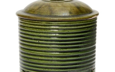 A rare Chinese green-glazed pottery tripod jar and cover, Tang...