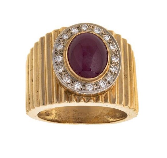 A ruby and diamond ring , collet set with an oval cabochon ruby framed by brilliant-cut diamonds, to a fluted tapering mount, ring size K