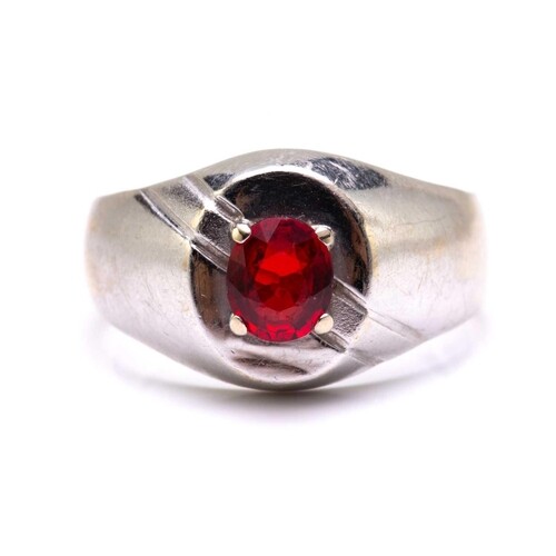 A signet ring set with synthetic ruby, comprises an oval-cut...