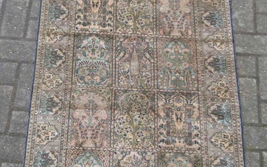 A silk Turkish Hereke rug with a blue and green ground colour 135 x 77 cm
