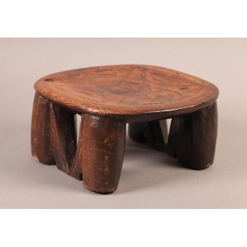 AN AFRICAN TRIBAL NECK REST OR PILLOW, the oval top carved a...
