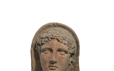 AN ETRUSCAN TERRACOTTA VOTIVE HEAD OF A YOUTH, CIRCA 3RD-2ND CENTURY B.C.