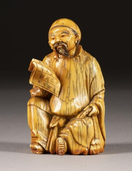 AN IVORY CARVED STATUE OF A LITERATUS