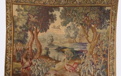 An 18th century tapestry, French, designed with cranes, crows and rabbits in a woodland, a