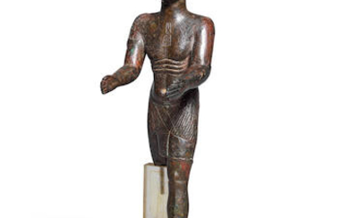 An Egyptian bronze figure of a priest