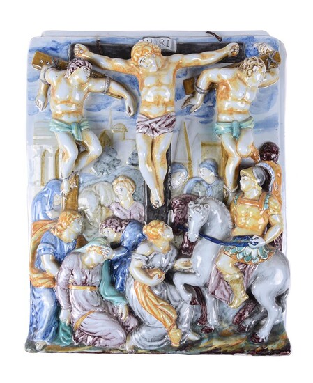 An Italian maiolica wall tile moulded in relief with The Crucifixion