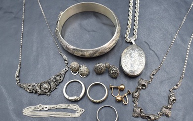 An assortment of silver and white metal jewellery, including a large hinged bangle with decorative