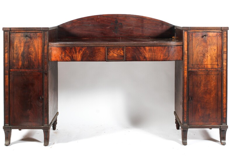 An early 19th century mahogany sideboard, the D-shaped top with reeded front and two frieze drawers