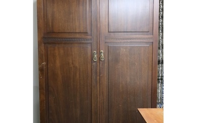 An early 20th century mahogany compactum wardrobe with pair ...
