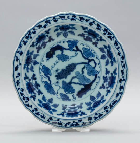 CHINESE UNDERGLAZE BLUE AND WHITE PORCELAIN SHALLOW DISH With a shaped edge, and lotus leaf, vine and spider decoration. Six-charact...