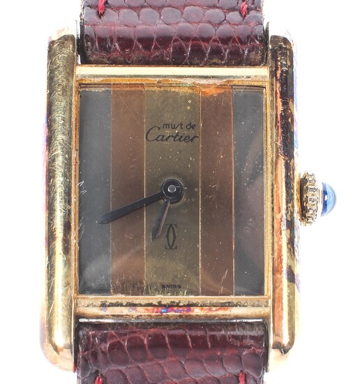 Cartier. A ladies Must de Cartier silver gilt square face wrist watch on brown leather strap.