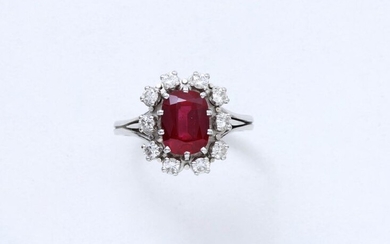 Daisy ring in 750 thousandths white gold set with a faceted oval red stone in claw setting imitating ruby in a setting of brilliant diamonds. French work.