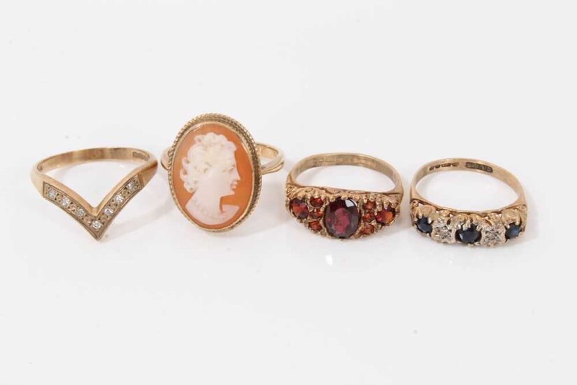 Four 9ct gold rings to include 1970s sapphire and diamond five stone ring in carved scroll setting, similar style garnet ring, diamond set wishbone ring and cameo ring