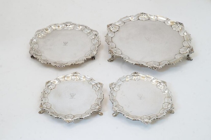 Four silver salvers, comprising: an Edwardian salver, Sheffield, 1909, William Hutton & Sons Ltd., 7cm dia., and two smaller matching examples, Sheffield, 1911, William Hutton & Sons Ltd, engraved to reverse WILSON & GILL 139 REGENT ST LONDON...
