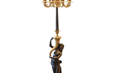 French floor lamp made of gilded and patinated bronze. The...