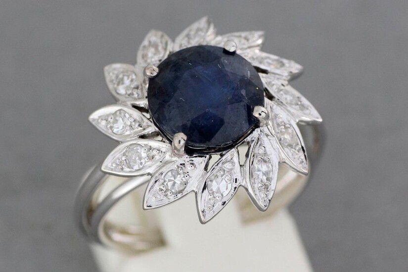 Gold "flower" ring set with a sapphire of about 4.1...