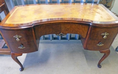 MAHOGANY LEATHER TOPPED SHAPED DESK WITH CENTRALLY SET DRAWER...