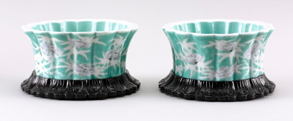 PAIR OF CHINESE GREEN AND WHITE PORCELAIN FLORIFORM DISHES Detailed flowers, including spider chrysanthemums, on a flower and vine-o...