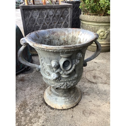 Pair of lead coated cast iron garden urns, two handled bodie...