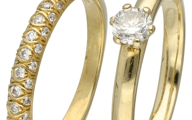 Set of a 14K. solitaire ring and an 18K. stacking ring, both set with diamonds....