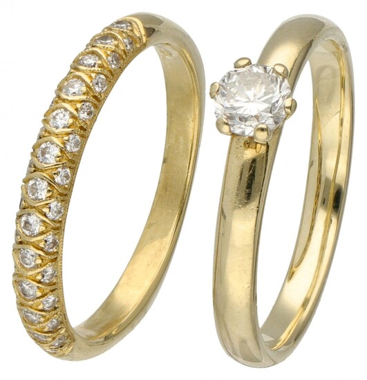 Set of a 14K. solitaire ring and an 18K. stacking ring, both set with diamonds....
