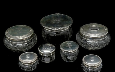 Seven Round Glass Jars with Sterling Silver Lids.