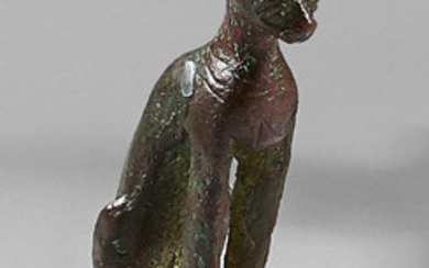 Statuette of Bastet sitting pussy. A necklace holding...