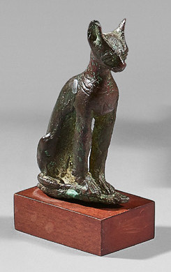 Statuette of Bastet sitting pussy. A necklace holding...