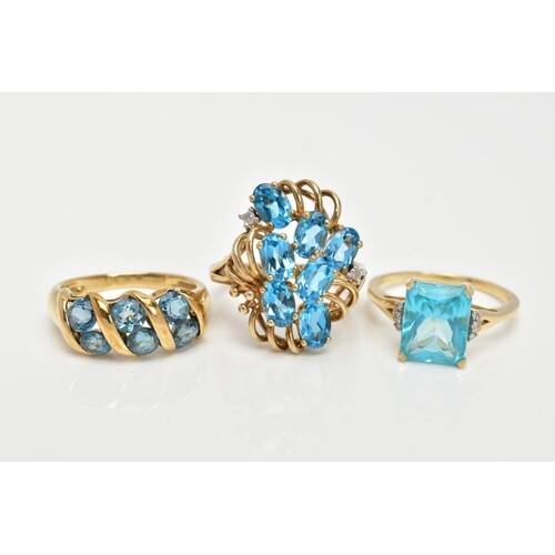 THREE 9CT GOLD TOPAZ DRESS RINGS, the first an openwork clus...