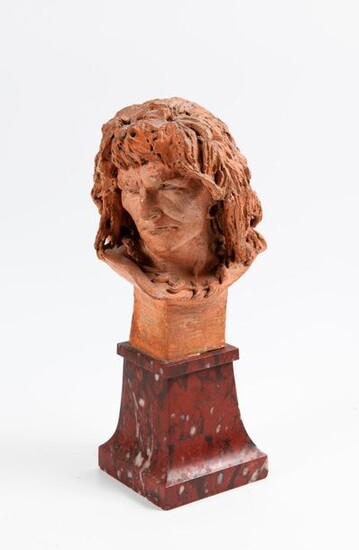 Terracotta man's head. It rests on a red marble pedestal (small accidents).