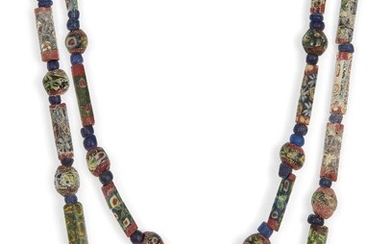 Two Roman mosaic glass bead necklaces Circa 1st Century B.C./A.D. and Later A necklace composed of eight spherical millefiori beads, interspersed with seven faceted tubular mosaic glass beads and plain blue glass bead spacers, 43cm; and another...