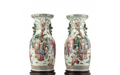Two famille rose baluster vases, with wood stands (defects) China, 19th century (h. 44 cm.)
