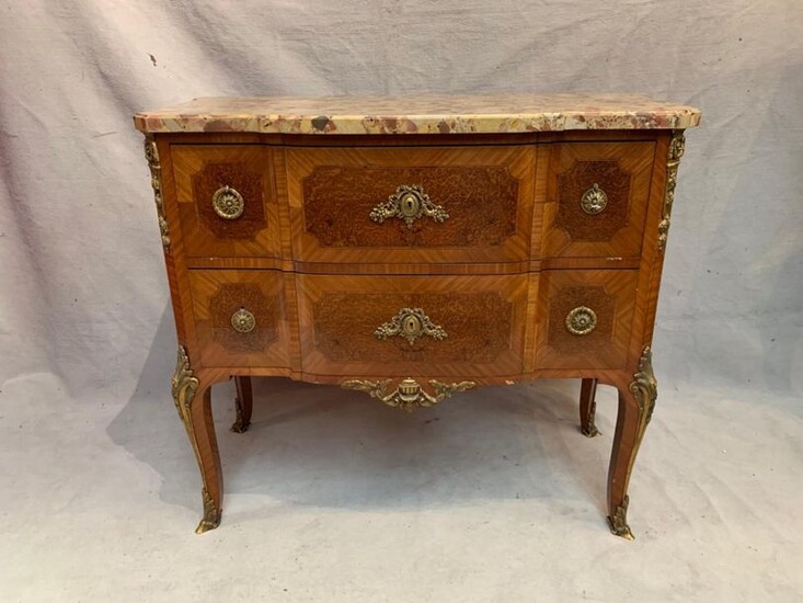 Veneered wood chest of drawers forming a desk, opening with two drawers, one revealing a leather-wrapped top and four small drawers. It rests on four arched legs. Gilded bronze ornamentation, such as lock entries, drawer handles and clogs. Breccia...