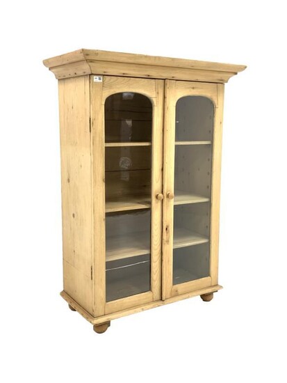 Victorian pine bookcase, projecting cornice over two arched glazed...