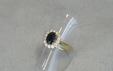 A yellow gold (eagle) ring centred on a sapphire in...