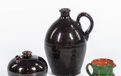 Three American Pottery Items, 19th century, a small green-glazed redware jug; a brown-glazed redware jug with strap handle; and a small