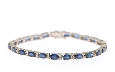A sapphire and diamond bracelet set with numerous oval-cut sapphires and numerous brilliant-cut diamonds, mounted in 14k white gold. L. 18.5 cm.