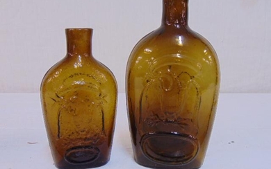 2 amber glass eagle flask bottles, in good condition,6"