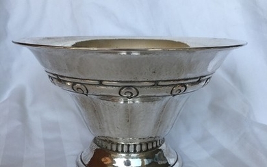 A Danish Arts & Crafts bowl of hammered silvered upon profiled base. Copenhagen 1919. Weight 308 gr. H. 12 cm. Diam. 20 cm.