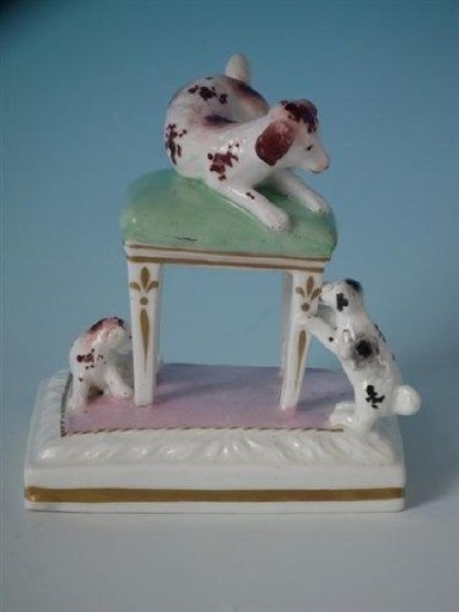 Staffordshire dog on stool with pups