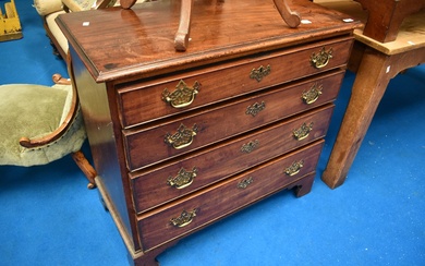A 19th Century mahogany chest of four long drawers having Georgian brass handles and bracket feet