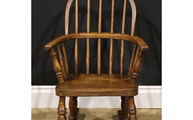A 19th century ash and elm child’s Windsor rocking chair, 68...