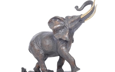 A 20th century patinated bronze elephant being set with gilt...