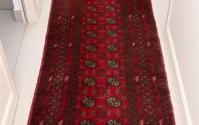 A Bokhara geometric woollen runner with two rows of twelve...