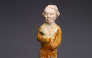 A CHINESE AMBER GLAZED POTTERY FIGURE OF FOREIGNER