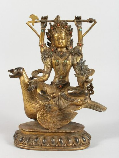 A CHINESE GILT BRONZE FIGURE OF A DEITY SEATED ON A