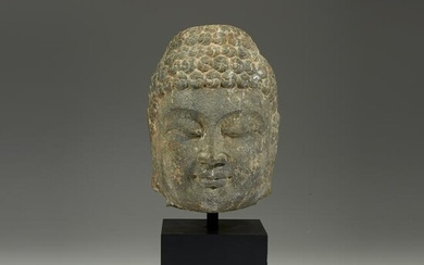A Chinese carved grey stone head of a Buddha, Northern
