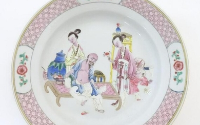 A Chinese famille rose plate decorated with an interior